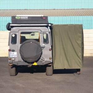 A small truck with a tarp covering the back of it.