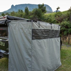 A tent is attached to the back of a truck.