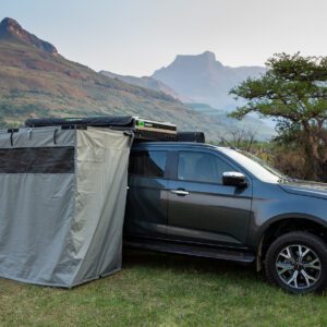 A truck with an awning attached to it's back.