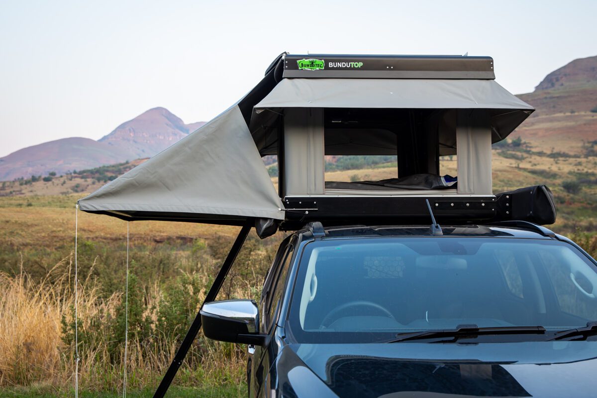 A car with an open roof and the top opened.