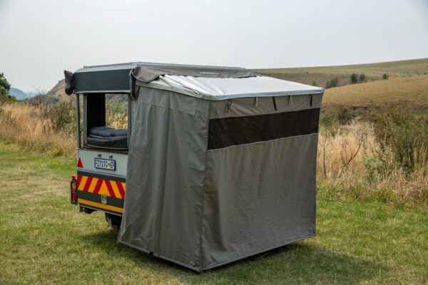 A small truck with a cover on the back.