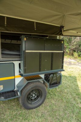 A large trailer with an open door and a storage compartment.