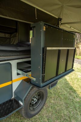 A truck with an open door and a large storage compartment.