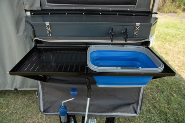 A grill with an open lid and a blue tub.