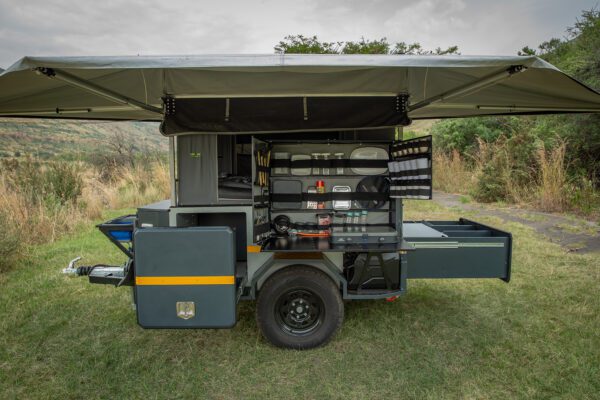 A trailer with an open door and storage compartment.