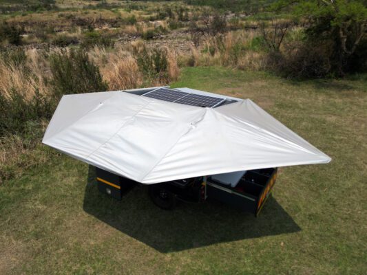 A tent with solar panels on top of it.