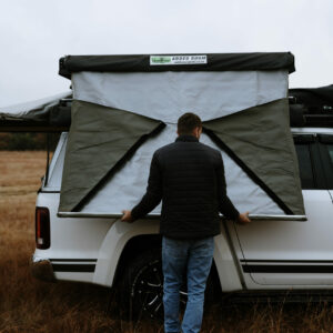 A man standing in the back of a white truck.