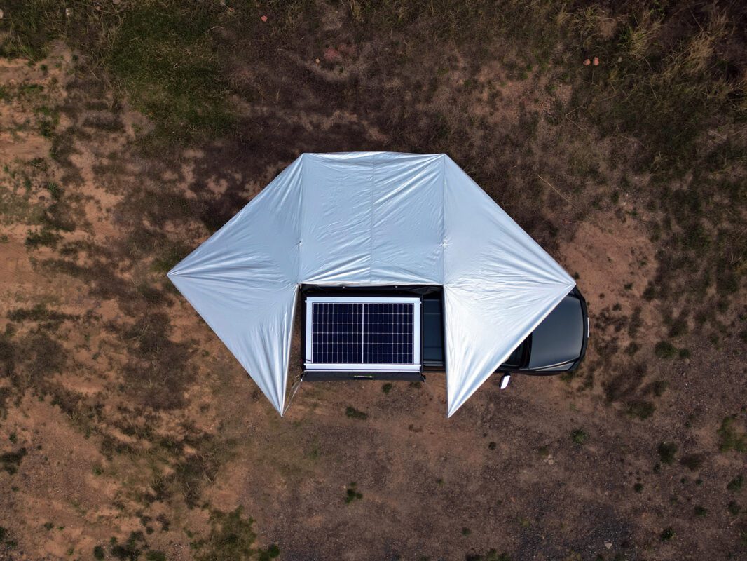 A solar panel is attached to the roof of an rv.