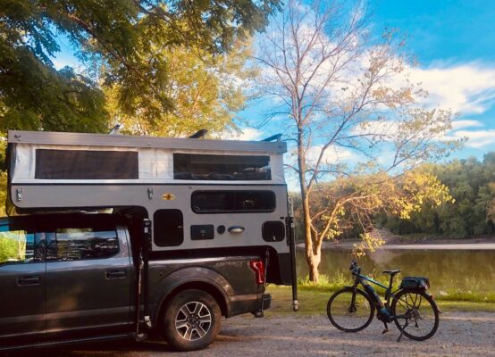 A truck with an rv parked next to it