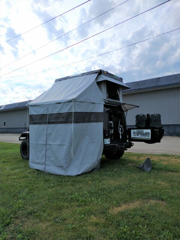 A truck with a tent on the back of it.