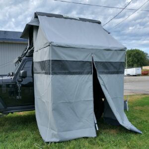 A utility vehicle with a tent attached to it.