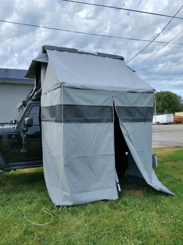 A utility vehicle with a tent attached to it.