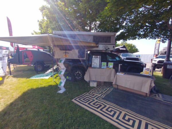 A camper van with a canopy and awning