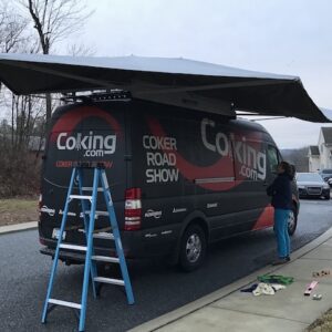 A van with an awning on the back of it