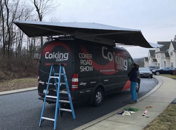 A van with an awning on the back of it