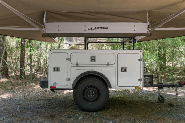 A white trailer with a canopy on top.