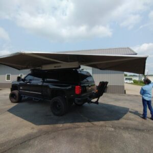 A truck with an awning attached to it