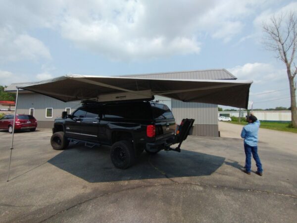 A truck with an awning attached to it