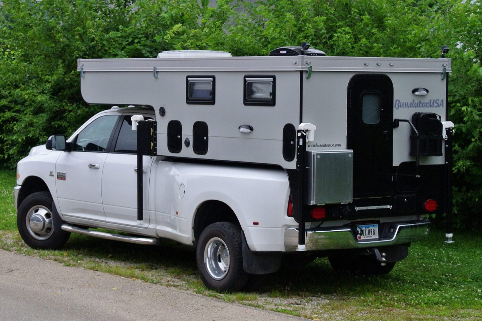 A truck with an rv in the back