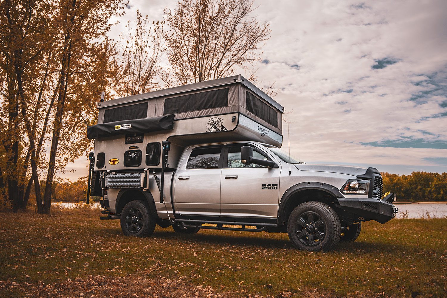 A truck with an rv on the back of it.