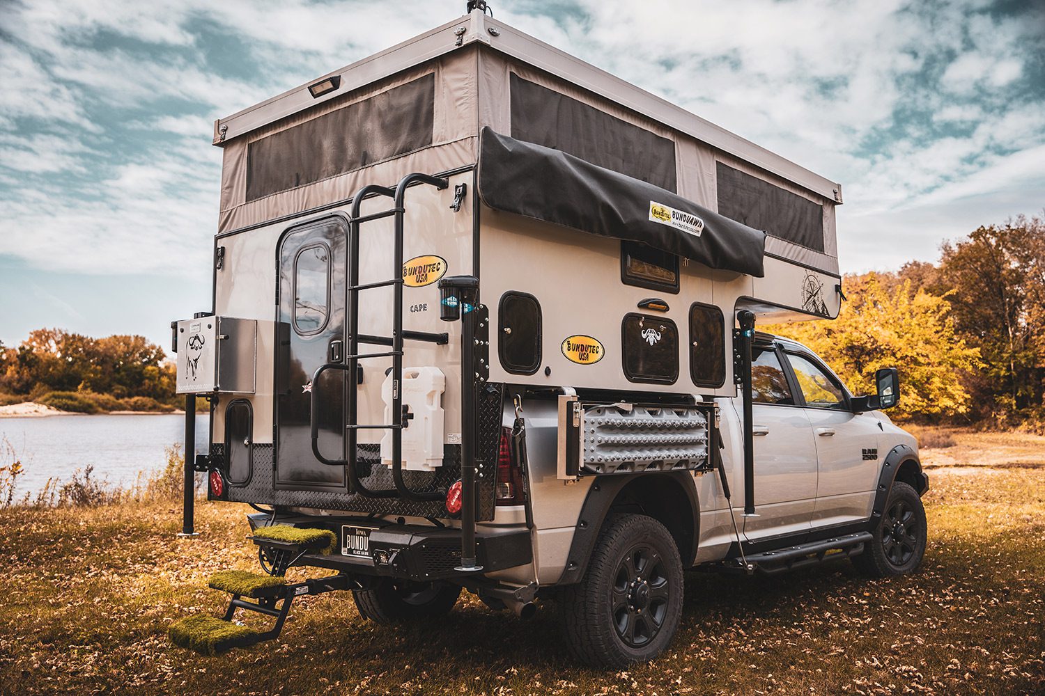 A truck with an enclosed camper on the back.