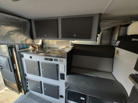 A kitchen with stove, oven and sink.