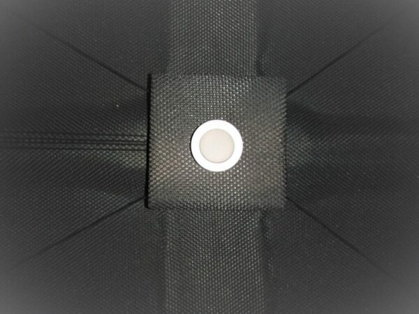 A close up of the button on a black umbrella