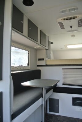 A table and chairs in the back of an rv.