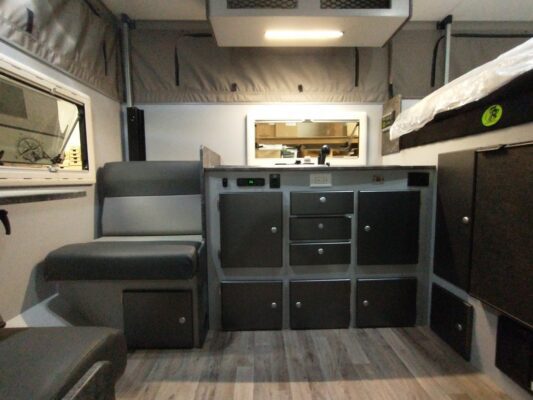 A room with black cabinets and a bed.