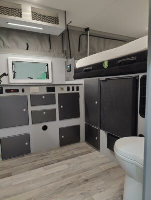 A bathroom with a bed and toilet in it