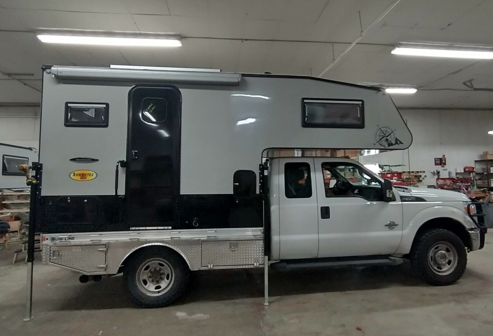 A truck with an rv in the back of it.