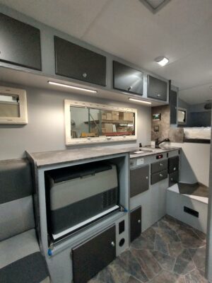 A kitchen with a tv and cabinets in it