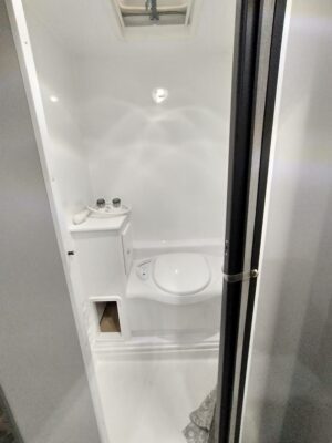 A white toilet sitting in the middle of a bathroom.