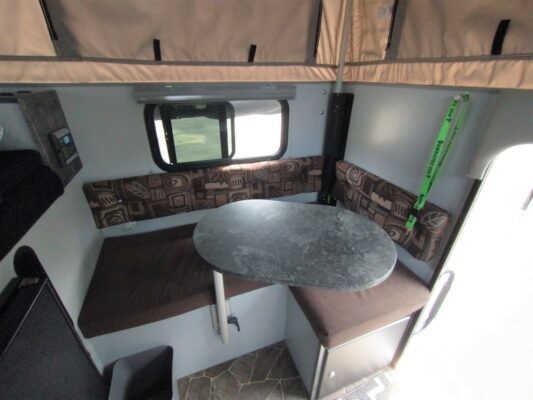 A table and chairs in the back of an rv.