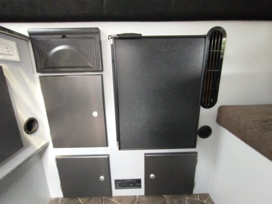 A black and white photo of some cabinets in the wall.