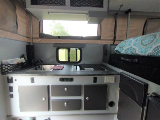 A kitchen with a stove and window in it