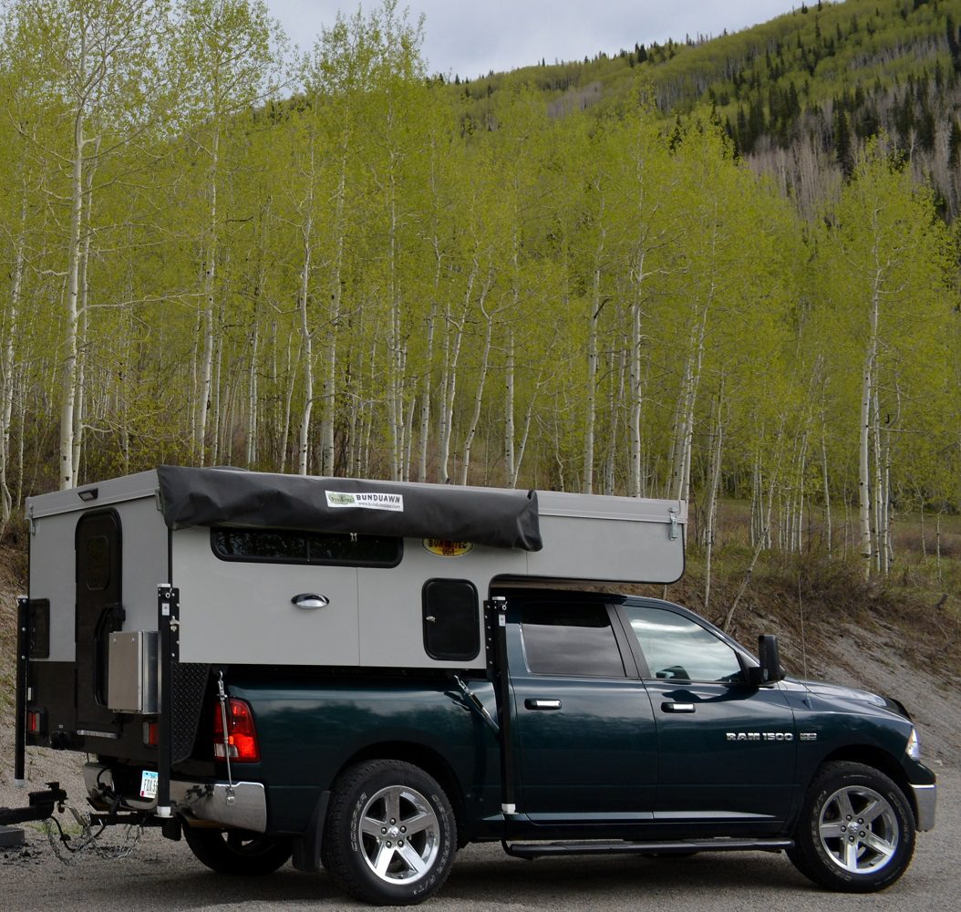 A truck with an rv in the back