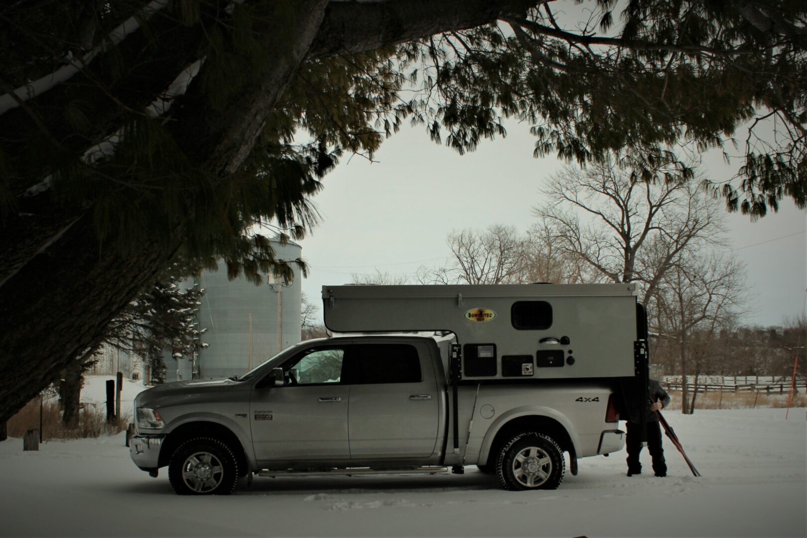 A truck with an rv in the back of it.