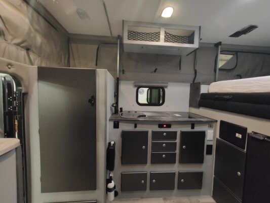 A kitchen with a sink and refrigerator in it