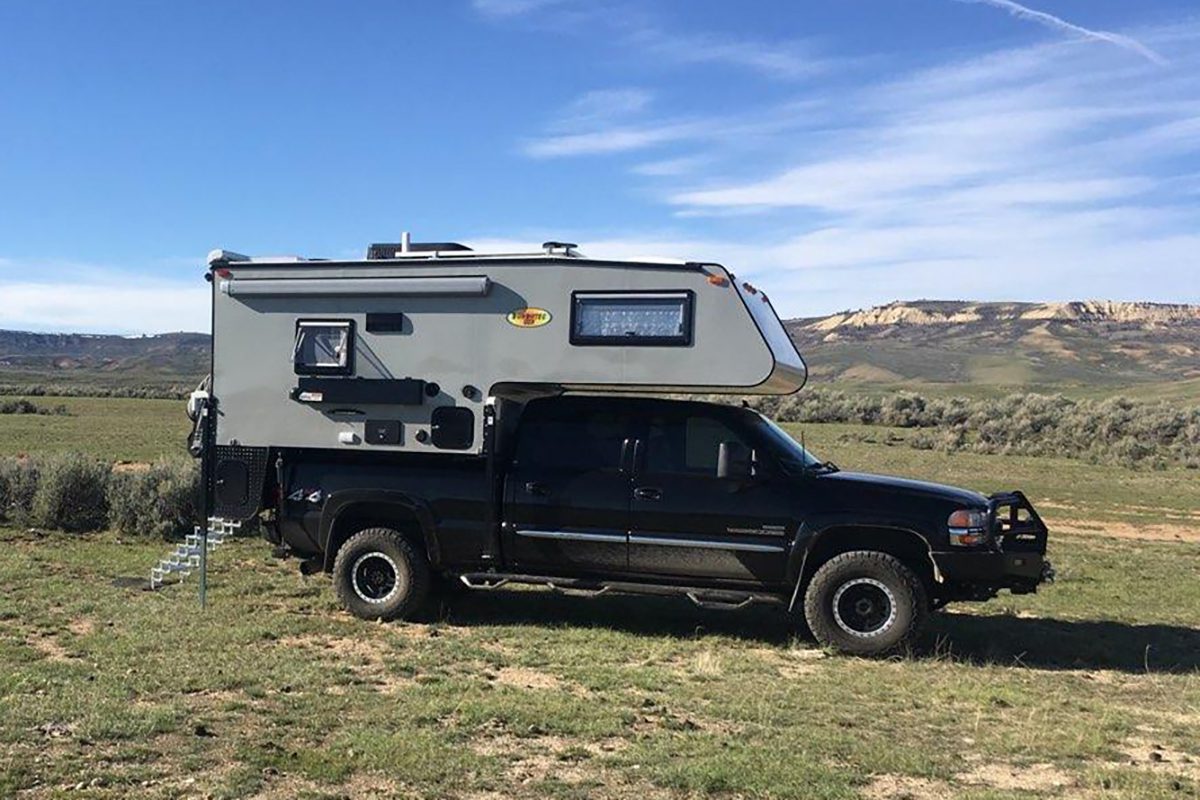 A truck with an rv in the back