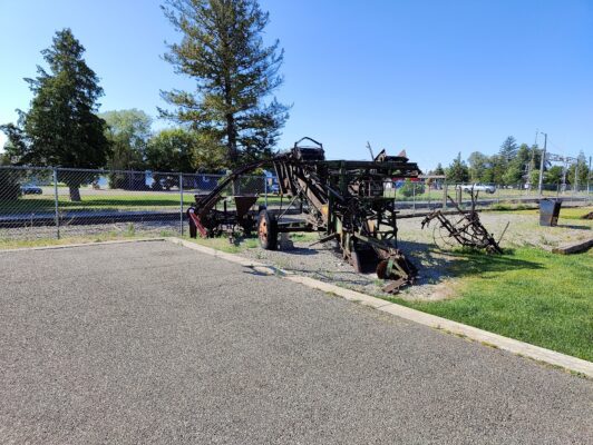 A field with some old machinery in the middle of it