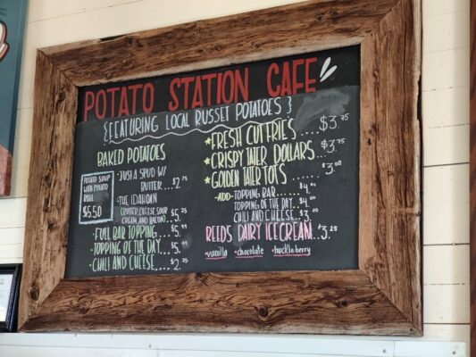 A chalkboard menu for potato station cafe.