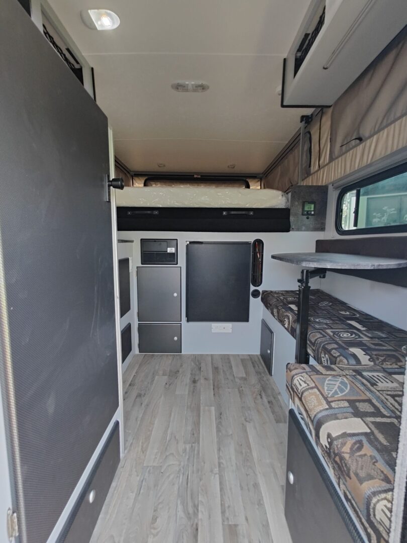 The interior of an rv with a bunk bed.