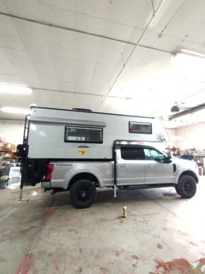 A camper truck parked in a garage.