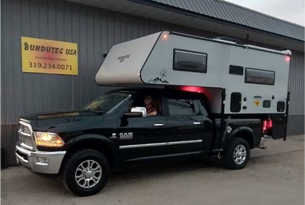 A truck with a camper attached to it.