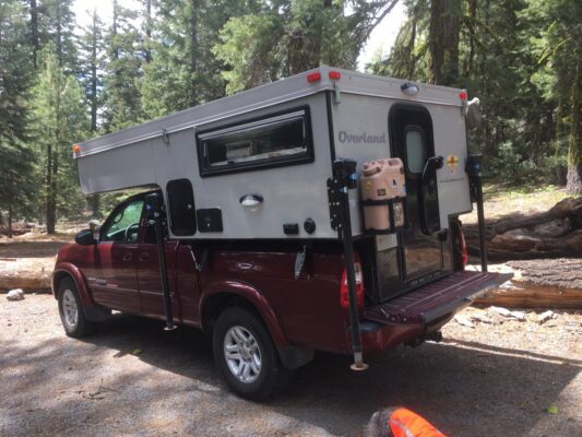 A camper on the back of a truck.