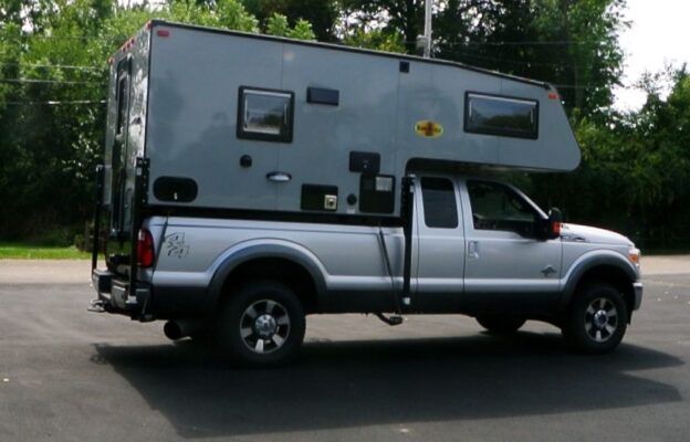 A truck with a camper attached to it.