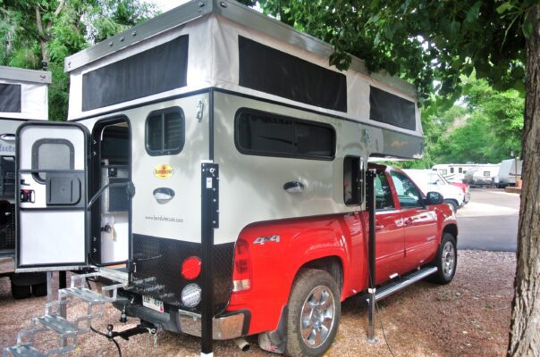 A truck with a camper attached to it.