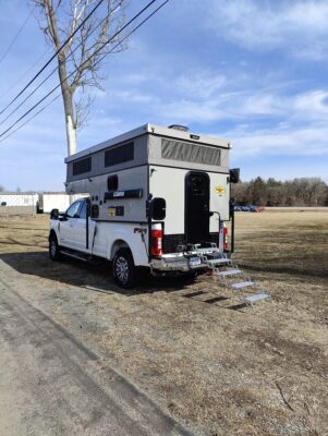 A camper parked on the side of a road.