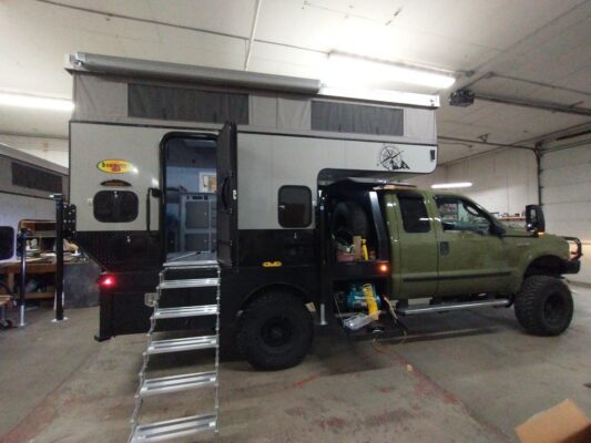 A truck with a camper attached to it.